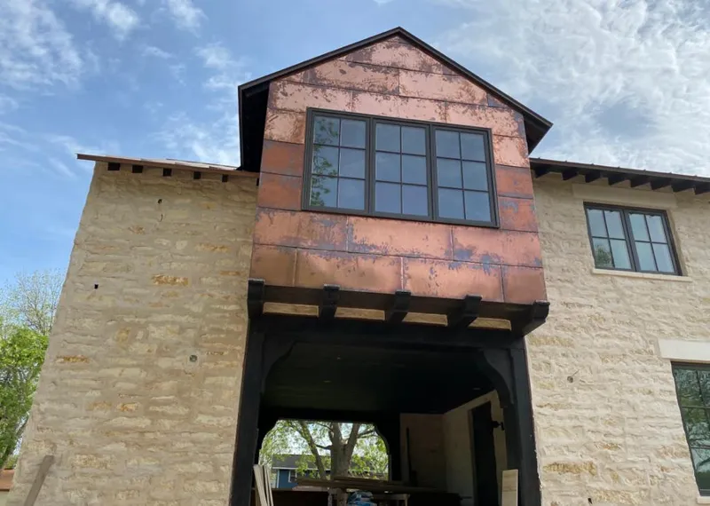 Copper metal panel facade on a stone building for Skylight Installation in Barberton
